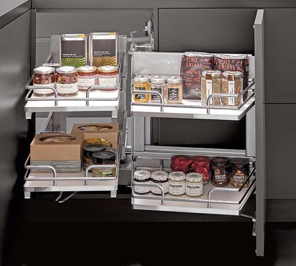 Pull-out corner cabinet organizer with multiple shelves holding jars, boxes, and condiments